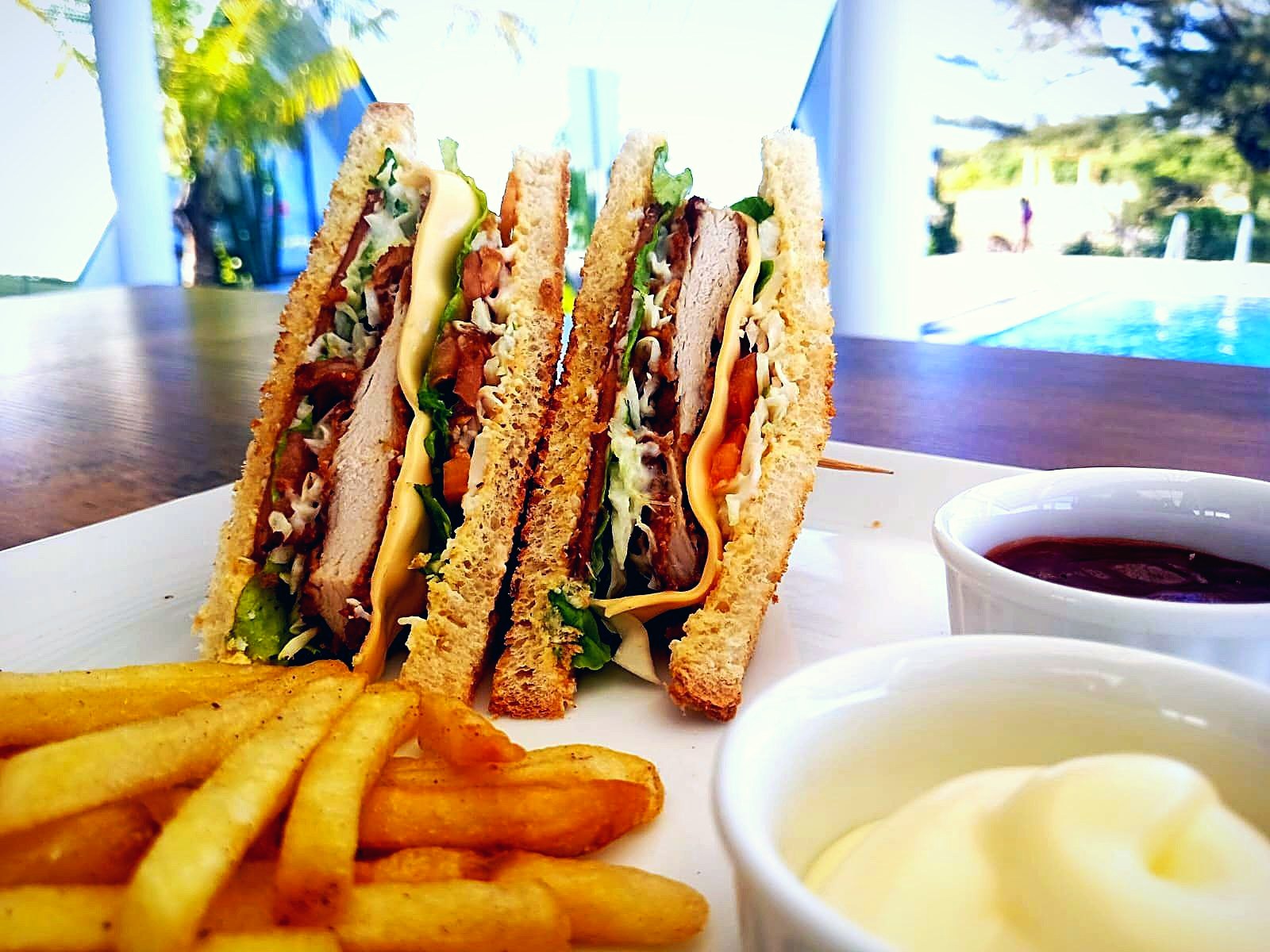 Club sandwich and fries served poolside