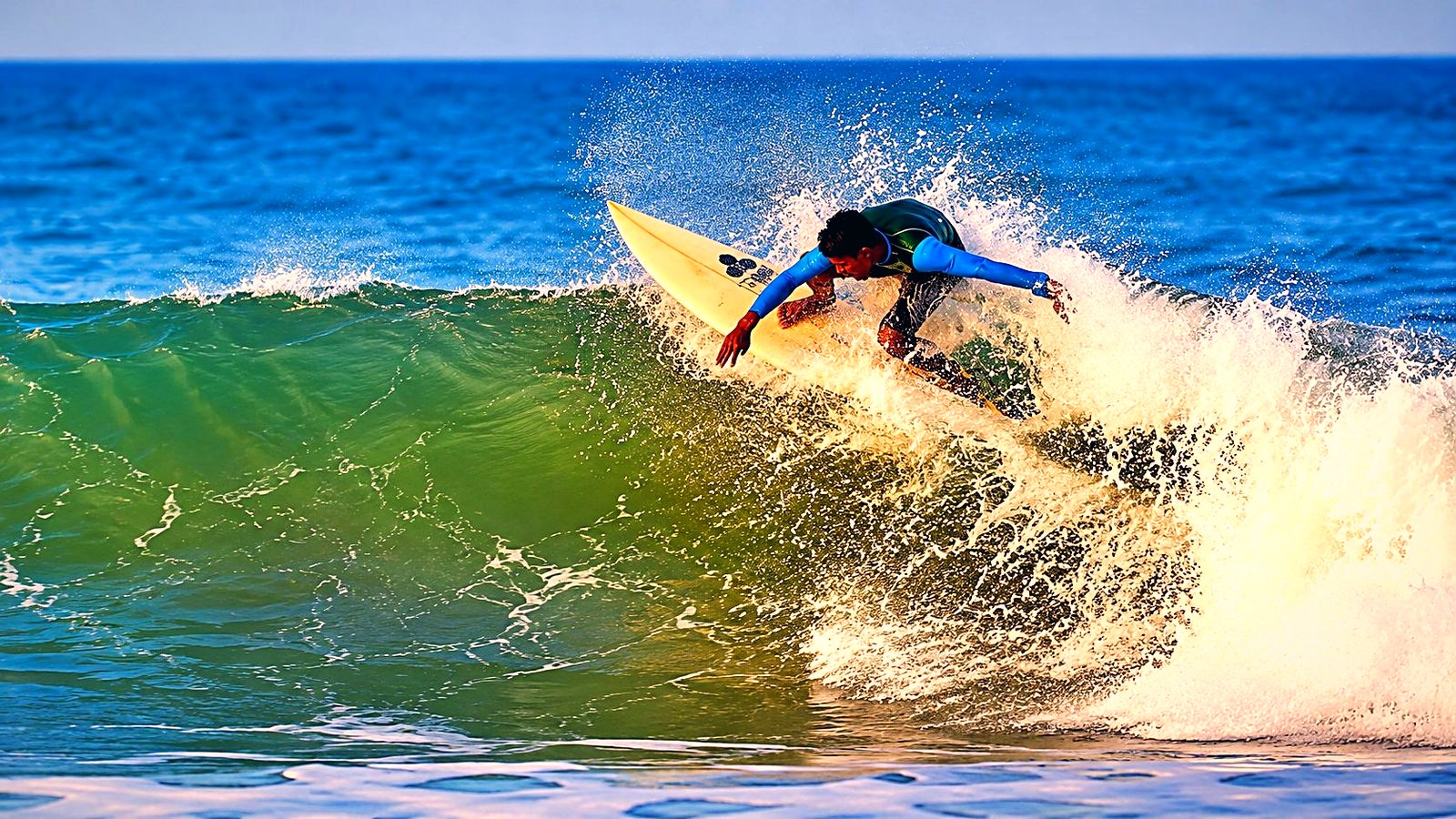 Surfer riding a wave at Arugam Bay